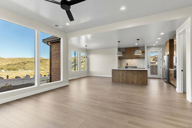 Open living room and kitchen with large windows overlooking the river valley